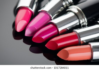 Lipstick. Fashion Colorful Lipsticks over black background. Lipstick tints palette, Professional Makeup and Beauty. Beautiful Make-up concept. Lipgloss. Lipsticks closeup
