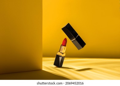 lipstick on a color background. yellow background. lipstick in flight