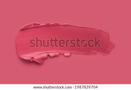 Lipstick pink red smudge swatch on same colored background