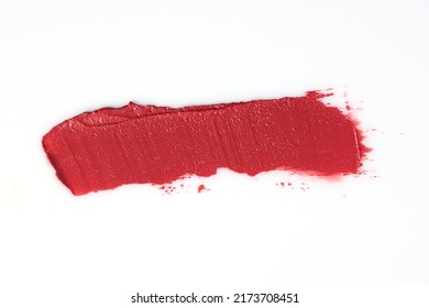 Lipstick smear smudge swatch isolated on white background. Lipstick makeup texture. Bright red color cosmetic product brush stroke swipe sample