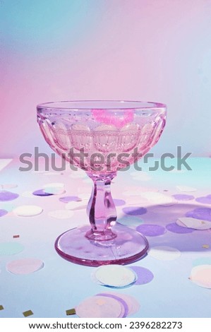 A Lipstick Stained Vintage Champagne Glass on a Dreamy, Pastel Purple Background