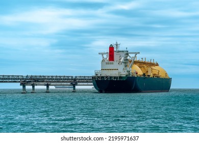 liquefied natural gas tanker vessel during loading at an LNG offshore terminal - Shutterstock ID 2195971637