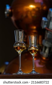 Liqueur Glasses In Front Of A Gin Distiller.                     