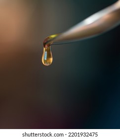 Liquid Amber Honey Dripping From Spoon Or Honey Dipper