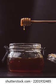 Liquid Amber Honey Dripping From Spoon Or Honey Dipper