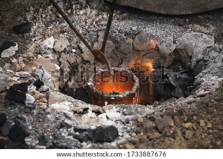 Liquid bronze is being heated to 1200°C. Casting bronze jewelry, Celtic Metalsmith. Experimental Archaeometallurgy. Viking Metal Casting. Bronze Age Forging. The lost-wax method, charcoal-fired hearth