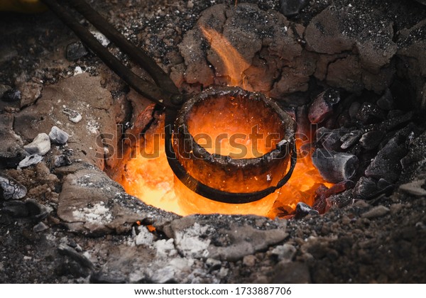 Liquid bronze is being heated to 1200°C. Casting\
bronze jewelry, Celtic Metalsmith. Experimental Archaeometallurgy.\
Viking Metal Casting. Bronze Age Forging. The lost-wax method,\
charcoal-fired hearth
