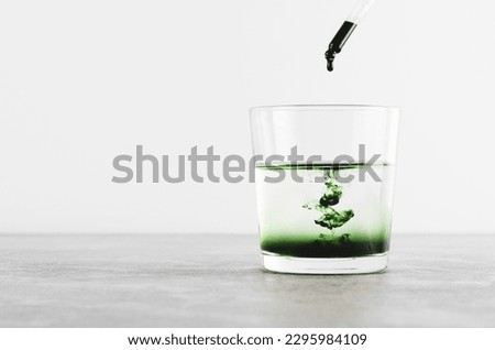 Liquid Chlorophyll in a Glass of Water, Superfood, Healthy Eating, Detox and Diet Concept