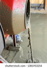 Liquid Concrete Mortar Is Poured From Red Cement Mixer