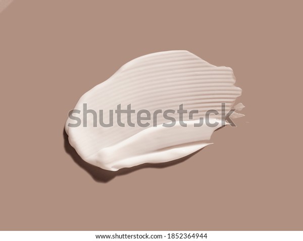 Liquid cream cosmetic smudge texture gray\
beige background