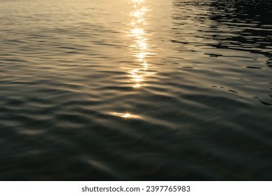 Liquid dark sea water surface rippled texture minimalistic abstract unfocused background with sunlight sparkles reflections and copy space - Powered by Shutterstock