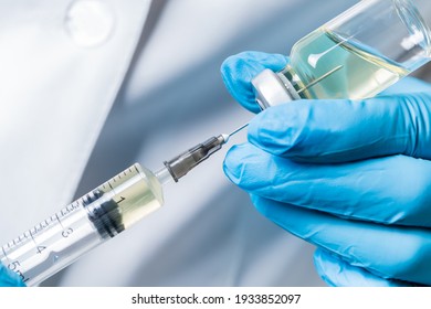 liquid drug or vaccine for treatment, flu in the hand of the doctor close-up