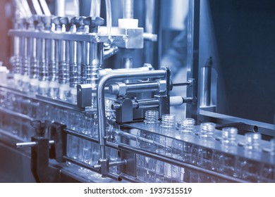 Liquid filling and bottle capping machine for industry. Beverage factory use automation and process instument for automatic of bottle cleaning, filling and capping machine in line production. - Shutterstock ID 1937515519