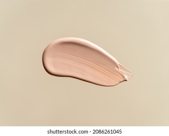 Liquid Foundation Isolated On Beige Nude Background. Smear Of Foundation For Face. Cosmetic Smear Of Liquid Foundation Or Bb-cream. Make-up Color Swatch