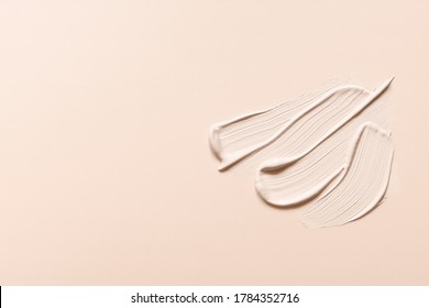 Liquid foundation strokes on nude color background. Makeup creamy texture. Skin tone cosmetic product smear smudge swatch