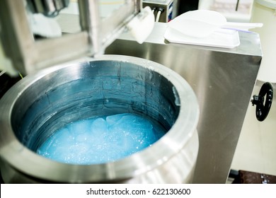 Liquid gel at mixer. Blue gel for health care products. Medical production.
