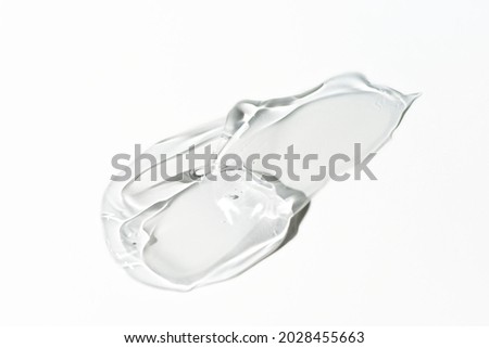 Liquid gel smear isolated on white background. Beauty cosmetic smudge such as pure transparent aloe lotion, facial jelly serum, cleanser, shower gel or shampoo top view.