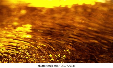 Liquid Golden Splash Texture, Abstract Beverages Background. Whisky, Rum, Cognac, Tea Or Oil.