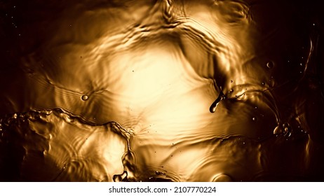 Liquid Golden Splash Texture, Abstract Beverages Background. Whisky, Rum, Cognac, Tea Or Oil.