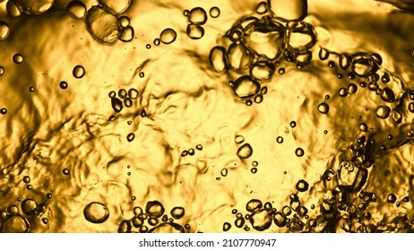 Liquid Golden Splash Texture, Abstract Beverages Background. Whisky, Rum, Cognac, Tea Or Oil.