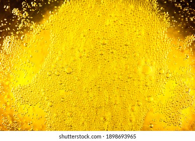 Liquid Gold-yellow Gasoline Bubbles Background On Beer Or Champagne Glass. Close Up, Macro Shot.