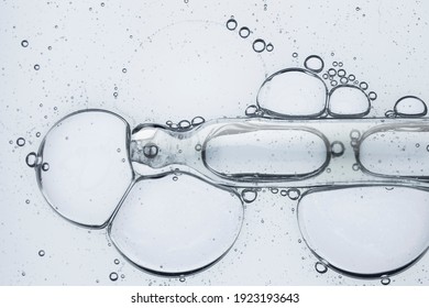 Liquid gray gel or serum on blue glass of microscop background