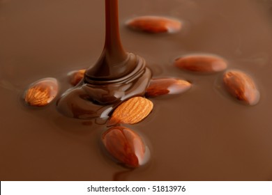 Liquid Hot Milk Chocolate Falling On Almonds