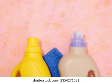 Liquid laundry detergent and a blue clean towel. Household chores and cleanliness. - Shutterstock ID 2354271531