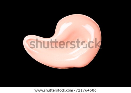 Liquid makeup foundations smear drop isolated on black background.