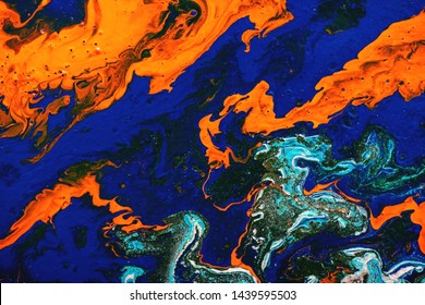 Liquid marbling paint background. Fluid painting abstract texture, blue, white, orange, black and turquoise. Color paint mix. Modern art.