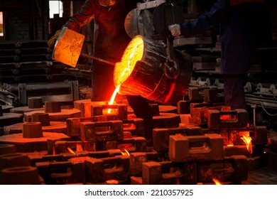 Liquid metal or cast iron poured into molds. Metal casting process with red high temperature fire in metallurgical factory. Metal part factory, foundry cast, heavy industry - Powered by Shutterstock