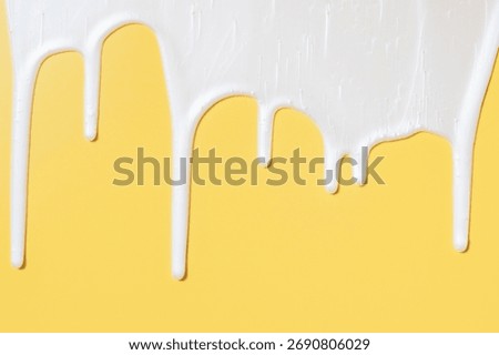 liquid moisturizing shampoo dripping down on yellow background close-up.