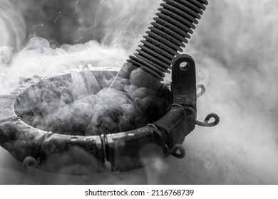 Liquid nitrogen in cryogenic container with pipe in smoke on experiment isolated black and white background