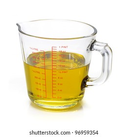 Liquid Oil In Measuring Cup Isolated On White Background