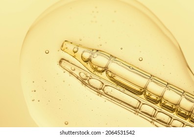 Liquid pipette serum pink gel on light yellow mirror background - Shutterstock ID 2064531542