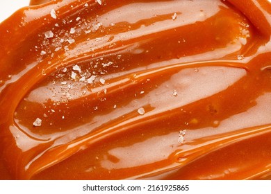 Liquid salted caramel syrup. Background of salted caramel paste. Texture Close up, top view. Sea salt pieces on caramel. - Shutterstock ID 2161925865