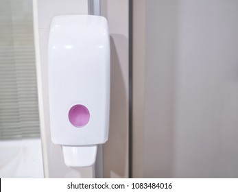 Liquid soap dispenser on the wall in the toilet for cleaning hands or body part to clear the dirt off to clean, Bathroom equipment for washing things. - Shutterstock ID 1083484016