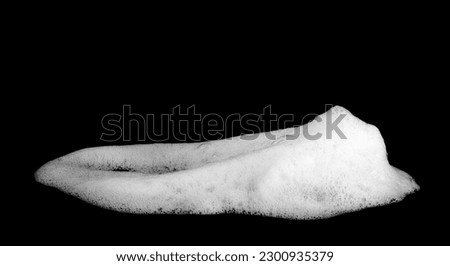 liquid white bubble texture from soap or shampoo. or shower gel and cosmetics white abstract clean Care and hygiene. isolated on black background