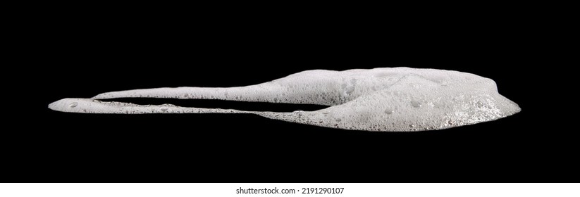 liquid white foam from soap or shampoo or shower gel. Abstract bubbles. isolated on a black background 