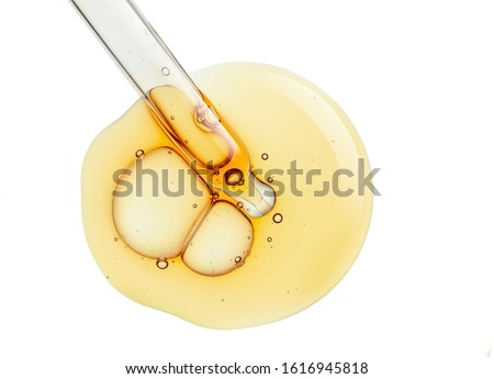 Liquid yellow gel or serum on white isolated background