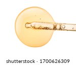 Liquid yellow-orange retinol or vitamin c gel or serum on a screen of microscope white isolated background