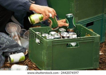 Liquor, person and hands with drinks, beer and beverage product for drinking a can in party. Closeup, outdoor or tin container for liquid, alcohol or crate in case package on ground or floor by trash