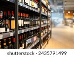 Liquor store concept. Wine bottles on shelves in the wine shop.