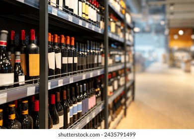 Liquor store concept. Wine bottles on shelves in the wine shop.