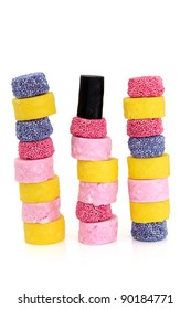 Liquorice allsort sweets in colourful abstract stack design isolated over white background.