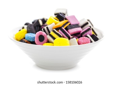 liquorice allsorts in a bowl isolated on a white background