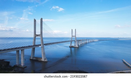 Lisboa, Portugal, April 24, 2022: Aerial View Of The Vasco Da Gama Bridge Is A Cable-stayed Bridge Located In The City Of Lisbon And Crosses The Tagus River. It Is The Second-longest Bridge In Europe.