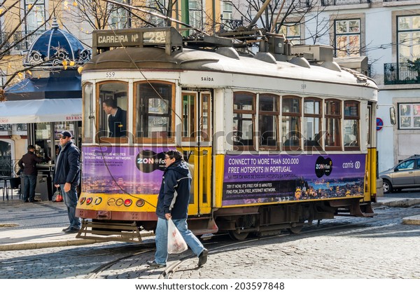 LISBOA, PORTUGAL - NOVEMBER 28: Traditional\
yellow tram/funicular on November 28, 2013 in Lisbon, Portugal.\
Carris is a public transportation company operates Lisbon\'s buses,\
trams, and funiculars.
