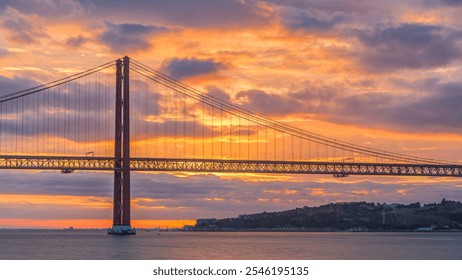 Lisbon city sunrise with April 25 bridge timelapse, River and waterfront early morning. Orange clouds on the sky - Powered by Shutterstock