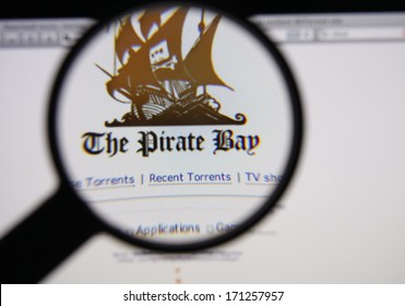 LISBON - JANUARY 14, 2014: Photo of The Pirate Bay homepage on a monitor screen through a magnifying glass.